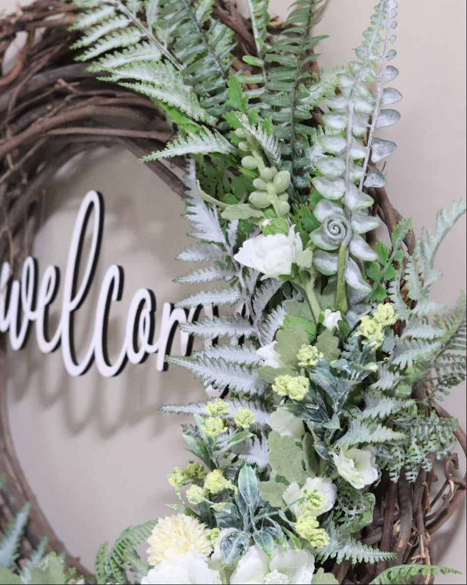 Welcome White Hollyhock and Yellow Ranunculus Fern Wreath