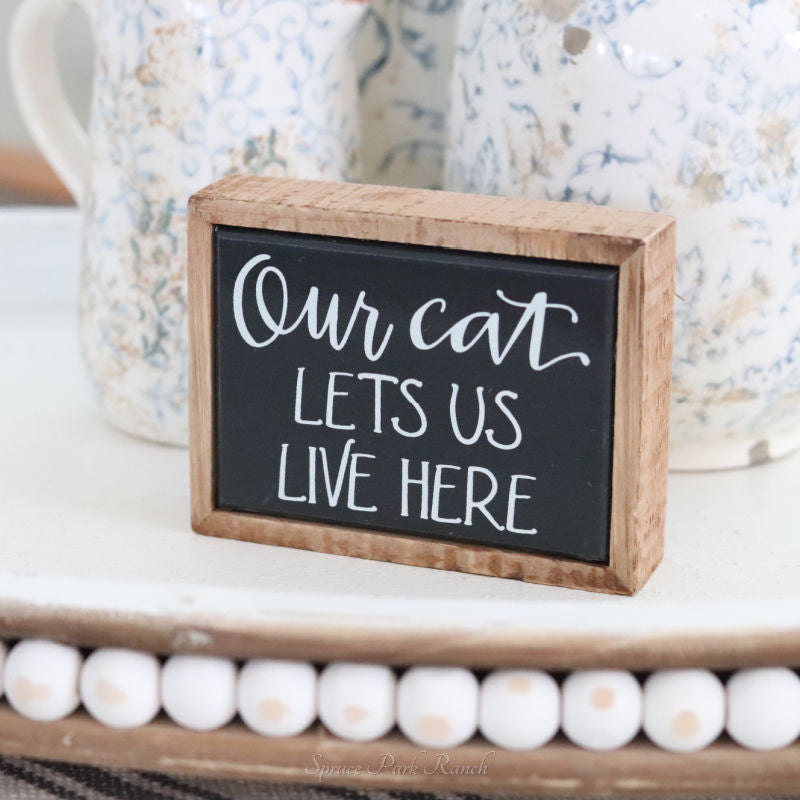 Our Cat Lets Us Live Here Mini Sign